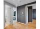 Hallway that leads to a bedroom and bathroom, with hardwood floors and neutral gray walls at 147 Wallace St, Northglenn, CO 80234