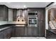 Modern kitchen with stainless steel appliances, stylish cabinets, and a sleek black countertop at 147 Wallace St, Northglenn, CO 80234
