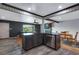 Modern kitchen with stainless steel dishwasher and dark countertops, connected to the living and dining areas at 147 Wallace St, Northglenn, CO 80234