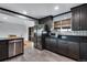 Stylish kitchen with dark cabinets, stainless steel appliances, and sleek countertops at 147 Wallace St, Northglenn, CO 80234