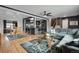 Open-concept living space featuring hardwood floors, modern gray walls, and a sleek kitchen bar with seating at 147 Wallace St, Northglenn, CO 80234