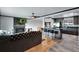 Open-concept living room featuring hardwood floors, fireplace, and a view of the kitchen with bar seating at 147 Wallace St, Northglenn, CO 80234