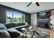 Living room with a large sectional sofa, fireplace, ceiling fan, and large windows at 147 Wallace St, Northglenn, CO 80234