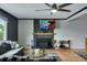 Hardwood floored living room featuring a fireplace, TV, comfortable sectional sofa, and modern furnishings at 147 Wallace St, Northglenn, CO 80234