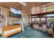 Enclosed porch with a tv, carpet, and multiple windows at 147 Wallace St, Northglenn, CO 80234