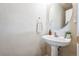 Elegant powder room with a pedestal sink, decorative mirror, and modern fixtures at 20000 Mitchell Pl # 9, Denver, CO 80249