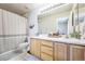 Well-lit bathroom with a vanity, a large mirror, and a shower-tub combination for convenience and comfort at 20000 Mitchell Pl # 9, Denver, CO 80249