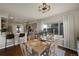 Bright dining room features a wood table set and views of the well-equipped kitchen at 20000 Mitchell Pl # 9, Denver, CO 80249