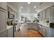 Well-lit kitchen featuring stainless appliances, and views into the dining and living spaces at 20000 Mitchell Pl # 9, Denver, CO 80249