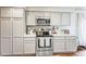 Modern kitchen with stainless steel appliances, ample cabinetry, and a stylish range hood at 20000 Mitchell Pl # 9, Denver, CO 80249