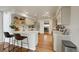 Updated kitchen with light-colored cabinets, quartz countertops, bar seating, and stainless steel appliances at 20000 Mitchell Pl # 9, Denver, CO 80249