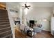 Spacious living room featuring a fireplace, high ceilings, and staircase to an open loft space at 20000 Mitchell Pl # 9, Denver, CO 80249