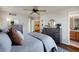 Comfortable main bedroom featuring a ceiling fan, stylish furniture, and access to an en-suite bathroom at 20000 Mitchell Pl # 9, Denver, CO 80249