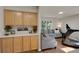 Comfortable sitting room featuring a built-in wooden cabinet and a treadmill for fitness activities at 20000 Mitchell Pl # 9, Denver, CO 80249