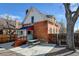 Brick home with a picnic table in the backyard, complemented by a stone pathway and mature trees at 4403 Alcott St, Denver, CO 80211