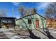 Backyard featuring a green garage with red door, a stone walkway, and a shaded pergola at 4403 Alcott St, Denver, CO 80211