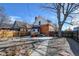 View of backyard showcases a brick house, stone walkway, and mature trees, offering a private retreat at 4403 Alcott St, Denver, CO 80211