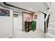 Basement features painted walls, exposed brick, metal ductwork, and a small workspace with a green stool at 4403 Alcott St, Denver, CO 80211