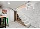 Basement stairs lead to a workspace area; features painted walls and a textured brick facade at 4403 Alcott St, Denver, CO 80211