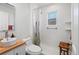 Bathroom with walk-in shower, white subway tile, and wood vanity at 4403 Alcott St, Denver, CO 80211