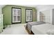 Bedroom with light green walls, white floors and shutters, and built-in shelves at 4403 Alcott St, Denver, CO 80211