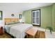 Bedroom with textured green walls, shuttered window, and wood accent table at 4403 Alcott St, Denver, CO 80211