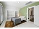 Bedroom featuring white floors, green accent wall, closet, and doorway at 4403 Alcott St, Denver, CO 80211