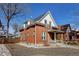 Charming brick home features a covered front porch, white trim, and a well-maintained yard at 4403 Alcott St, Denver, CO 80211
