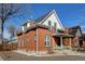 Charming brick home features a covered front porch, white trim, and a well-maintained yard at 4403 Alcott St, Denver, CO 80211