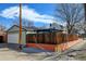 View of the detached garage and the surrounding landscaped exterior, featuring a unique orange retaining wall at 4403 Alcott St, Denver, CO 80211