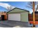A detached one car garage with white door and green exterior, plus address numbers on the side at 4403 Alcott St, Denver, CO 80211
