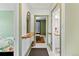 Hallway with a shelf and mirror leading to a bedroom and bathroom at 4403 Alcott St, Denver, CO 80211