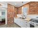 Farmhouse style kitchen featuring stainless steel sink, painted brick, and butcher block counters at 4403 Alcott St, Denver, CO 80211