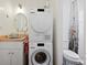 Efficient laundry room featuring modern washer and dryer, sink, mirror, and toilet at 4403 Alcott St, Denver, CO 80211