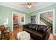 Relaxing living room featuring hardwood floors, green paint, and a leather couch at 4403 Alcott St, Denver, CO 80211