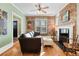 Inviting living room featuring exposed brick wall, a fireplace, and hardwood floors at 4403 Alcott St, Denver, CO 80211