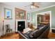 Cozy living room features a brick fireplace, hardwood floors, and comfortable seating at 4403 Alcott St, Denver, CO 80211