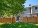 View of the backyard featuring a well-maintained lawn and a wooden fence for privacy at 9024 Gale Blvd # 3, Thornton, CO 80260
