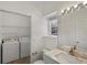 Bright bathroom featuring washer, dryer, and neutral decor at 9024 Gale Blvd # 3, Thornton, CO 80260