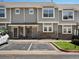 Charming townhome exterior with gray siding, stone accents, and visitor parking during the day at 9024 Gale Blvd # 3, Thornton, CO 80260