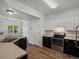 Well-lit kitchen with black and white cabinetry and stainless steel appliances at 9024 Gale Blvd # 3, Thornton, CO 80260