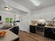 Modern kitchen with stainless steel appliances, black and white cabinets, and ample counter space at 9024 Gale Blvd # 3, Thornton, CO 80260
