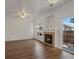 Bright living room featuring a cozy fireplace, wood floors, and a sliding glass door at 9024 Gale Blvd # 3, Thornton, CO 80260