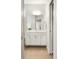 Bright bathroom features a modern vanity with white cabinets and a large mirror at 2110 Decatur St, Denver, CO 80211