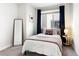 Bedroom with natural lighting, neutral walls, and cozy decor at 2110 Decatur St, Denver, CO 80211
