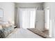 Bedroom bathed in natural light with sheer curtains and cozy throw blanket at 2110 Decatur St, Denver, CO 80211