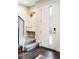 Welcoming entryway features a seating area with a coat rack and frosted glass front door at 2110 Decatur St, Denver, CO 80211