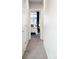 Hallway view towards a bedroom with natural light and dark blue curtains at 2110 Decatur St, Denver, CO 80211