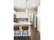 Modern kitchen with stainless steel appliances, breakfast bar and dark hardwood floors at 2110 Decatur St, Denver, CO 80211