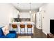 Modern kitchen with stainless steel appliances, white cabinets, and a breakfast bar at 2110 Decatur St, Denver, CO 80211